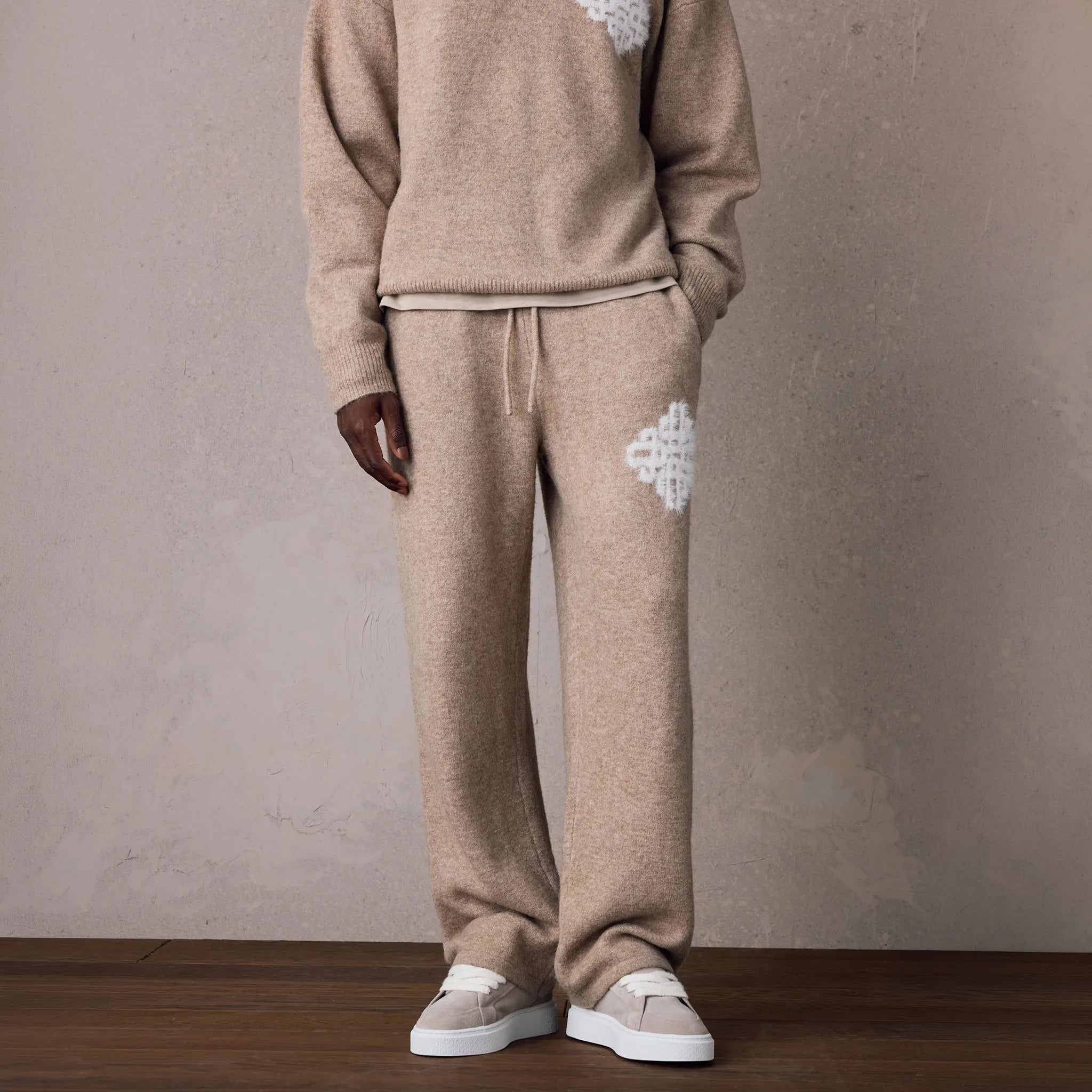 Detailed Front View of The Couture Club Emblem Fluffy Knit Beige Sweatpants